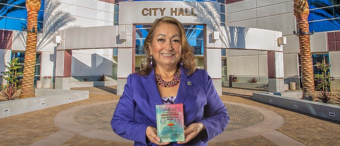 Councilman Baca holding the award.