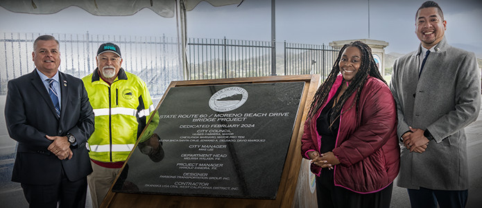 City officials at the memorial sign on the new bridge.